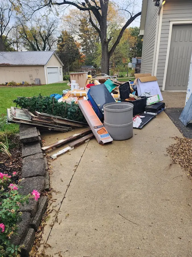Dumpster being loaded with debris for Demolition Dumpster Rental in Paw Paw